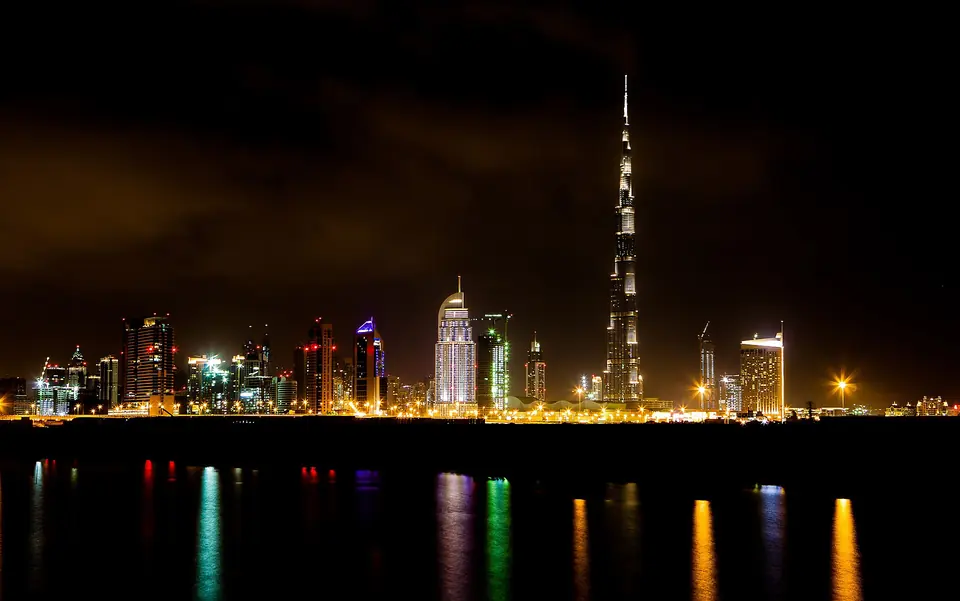 Dubai skyscrapers reflected in the water at night